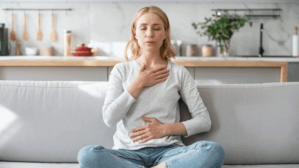 woman practicing breathwork at home
